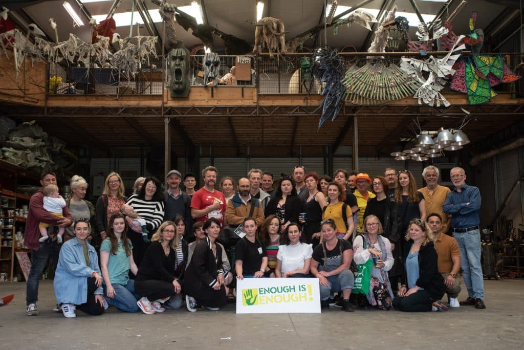 Portrait of 40 people - ISACS members - posing in a group photo with sign from the Alliance for Insurance Reform that reads Enough is Enough.
