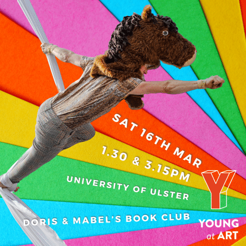 Doris, wearing a pantomime horse's head in on an aerial silk