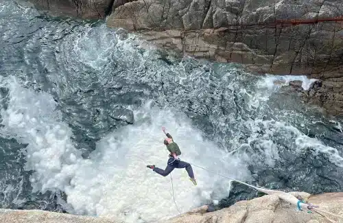 Circus aerial artist performing acro aerial on the ocean