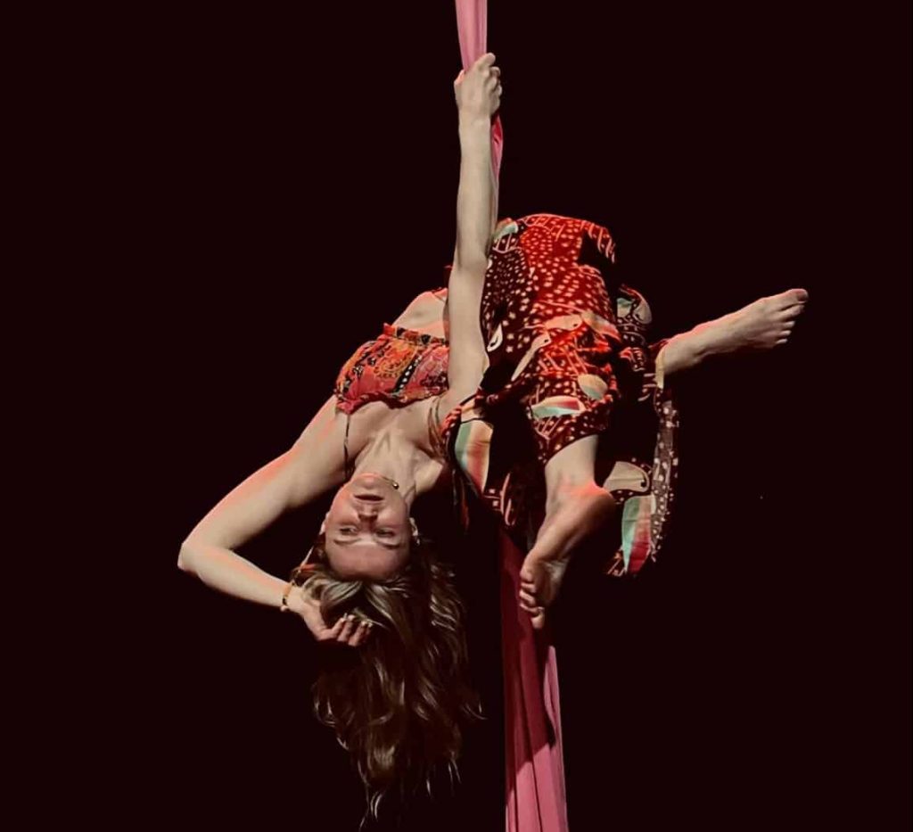 Woman practicing aerial dance on silk