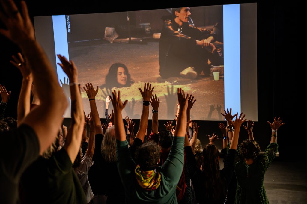 2 people performing and interacting with audience in a theatre