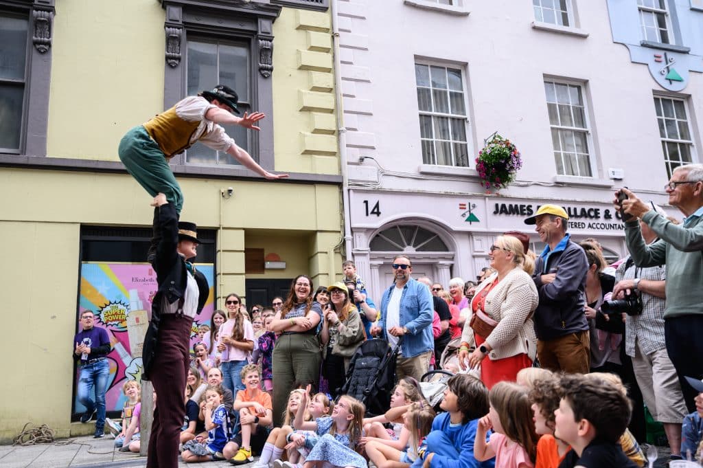 outdoor arts performers surrounded by audiences