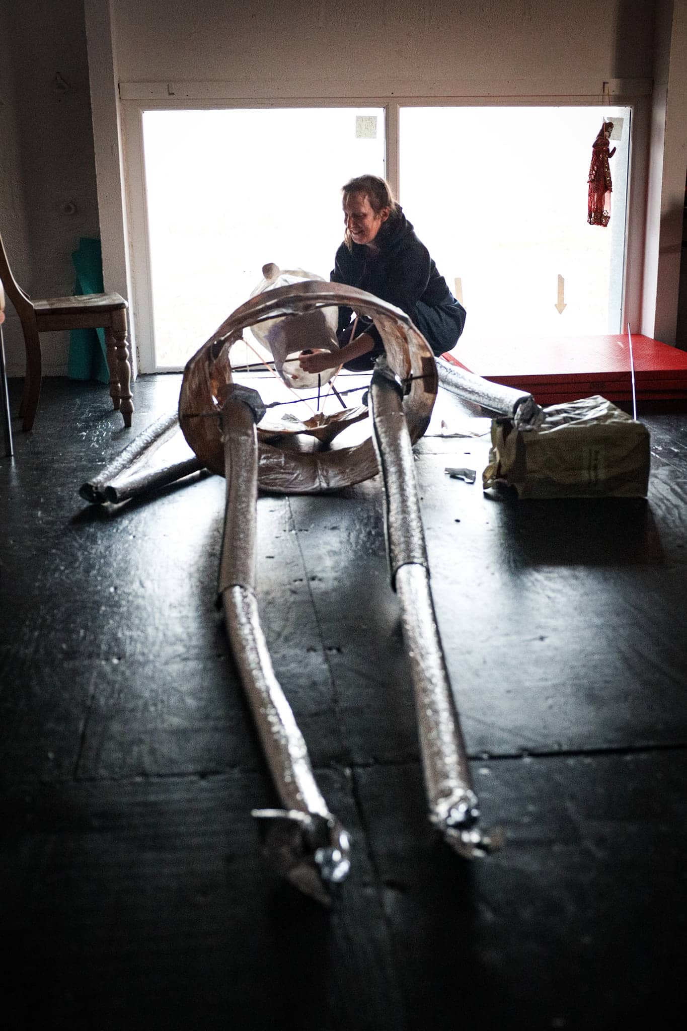 A woman assembling a giant puppet